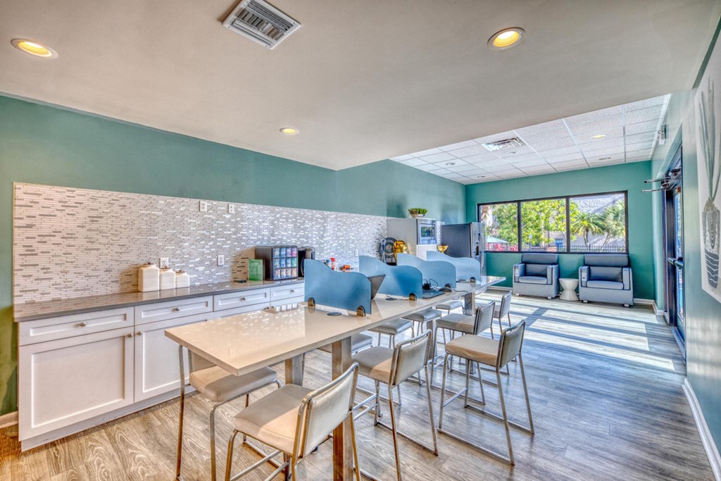 A kitchen with a table and chairs in the foreground.