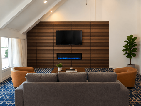 A modern living room with a grey couch and a flat screen TV mounted on a wooden wall.