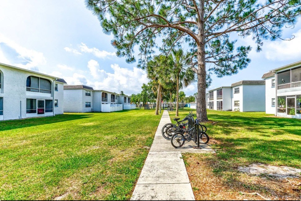 a row of houses with bicycles parked in the grass
