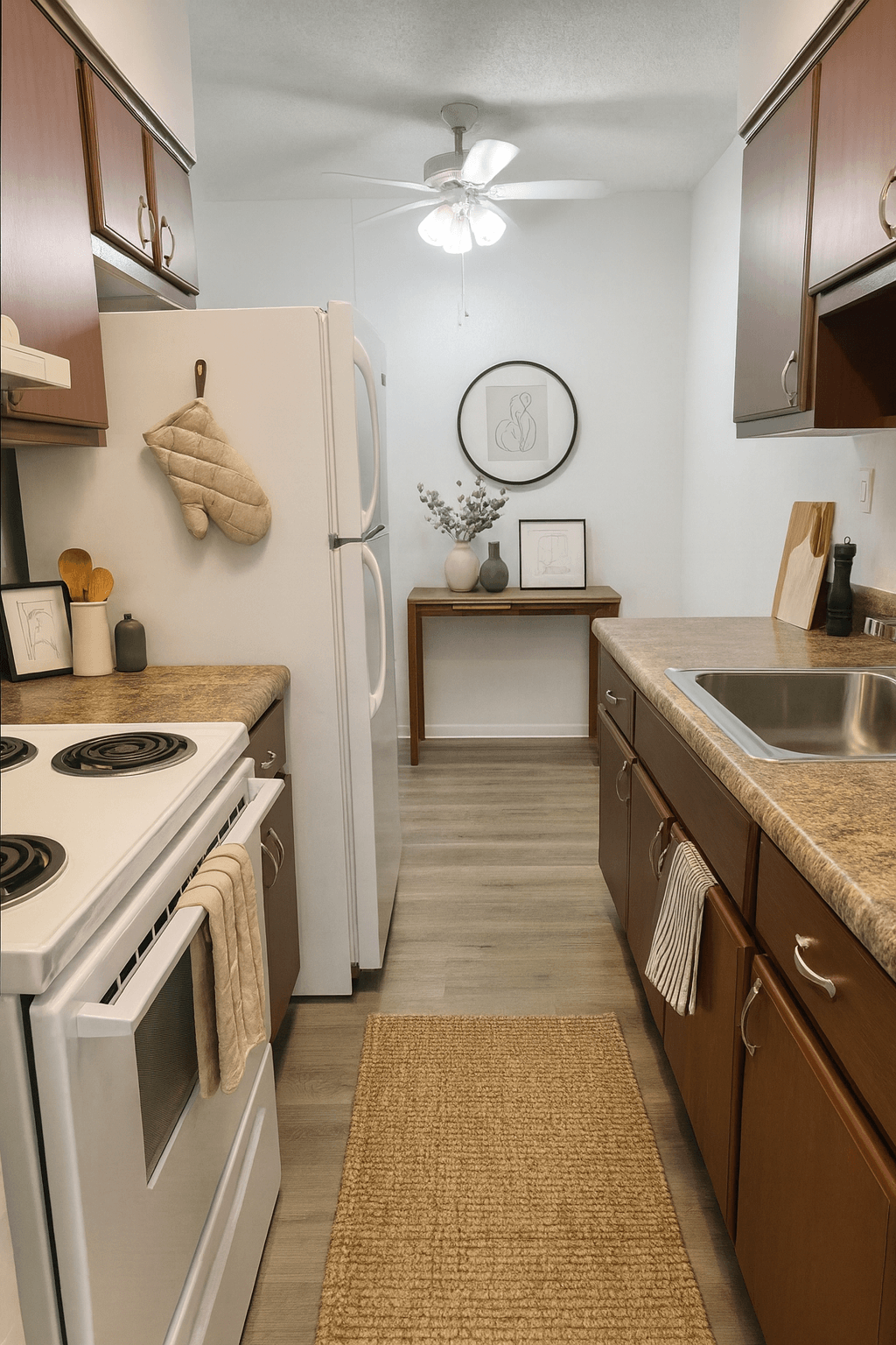 A kitchen with a white stove top oven and a white refrigerator.