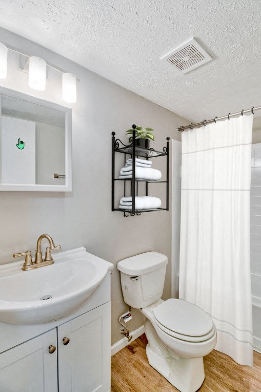 A white toilet sits next to a sink in a bathroom.