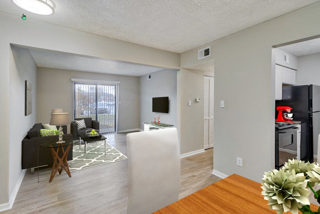 A living room with a couch, chairs, and a television.