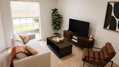 A living room with a couch, chair, and television.