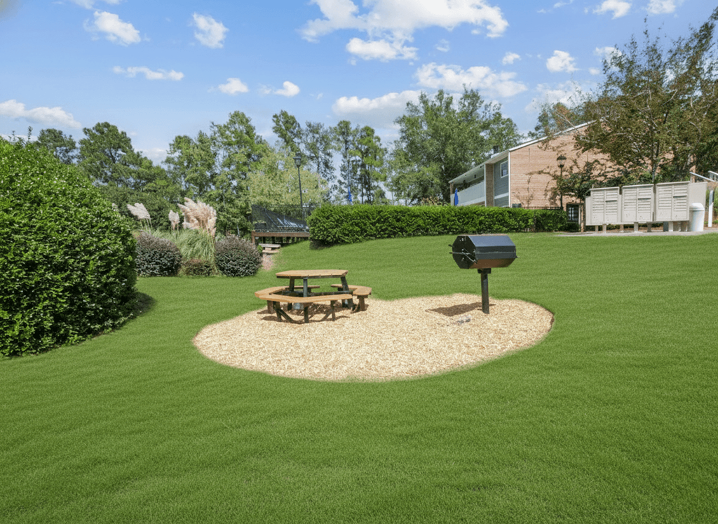 A picnic table sits in the middle of a grassy area.