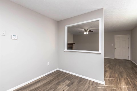 A room with a window and a ceiling fan.