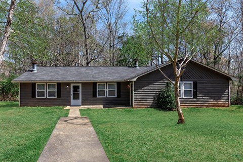 A house with a grey roof and a white door.