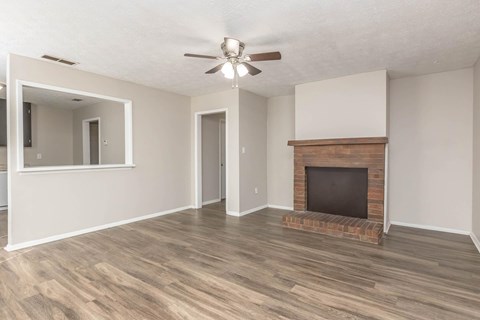 A room with a fireplace and a ceiling fan.