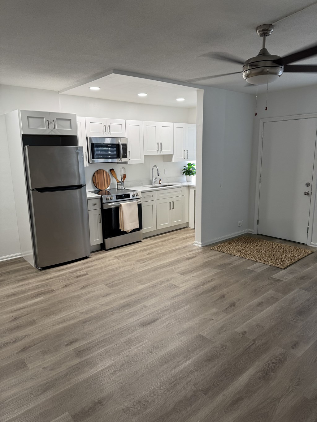 A kitchen with a refrigerator, stove, and oven.