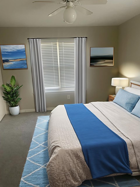 A bedroom with a bed, a plant, a window with blinds, and pictures on the wall.