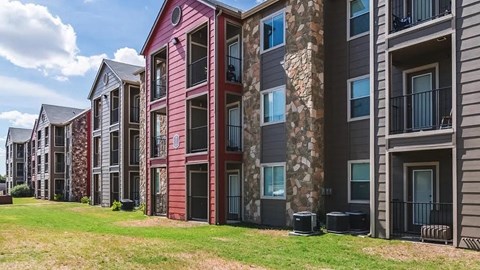 A row of apartment buildings with balconies and windows.