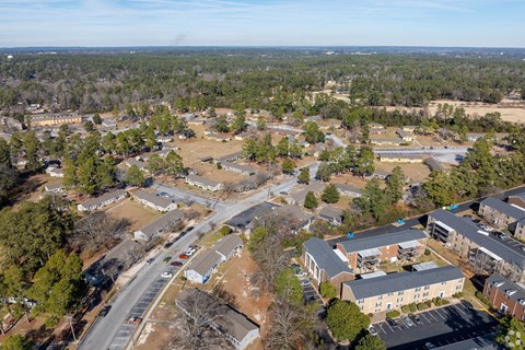 A bird's eye view of a residential area with houses and roads.