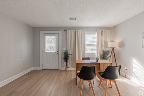 A room with a desk and two chairs.