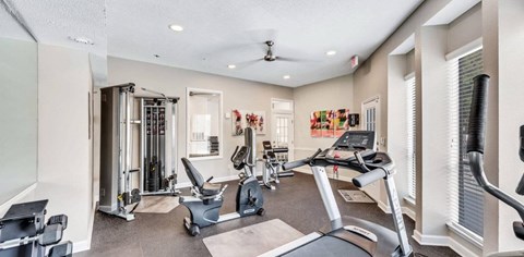 A spacious home gym with a variety of exercise equipment.