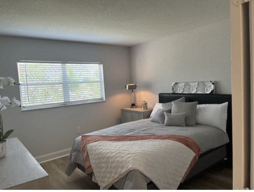 a bedroom with a bed and a window