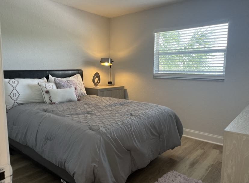 a bedroom with a bed and a window