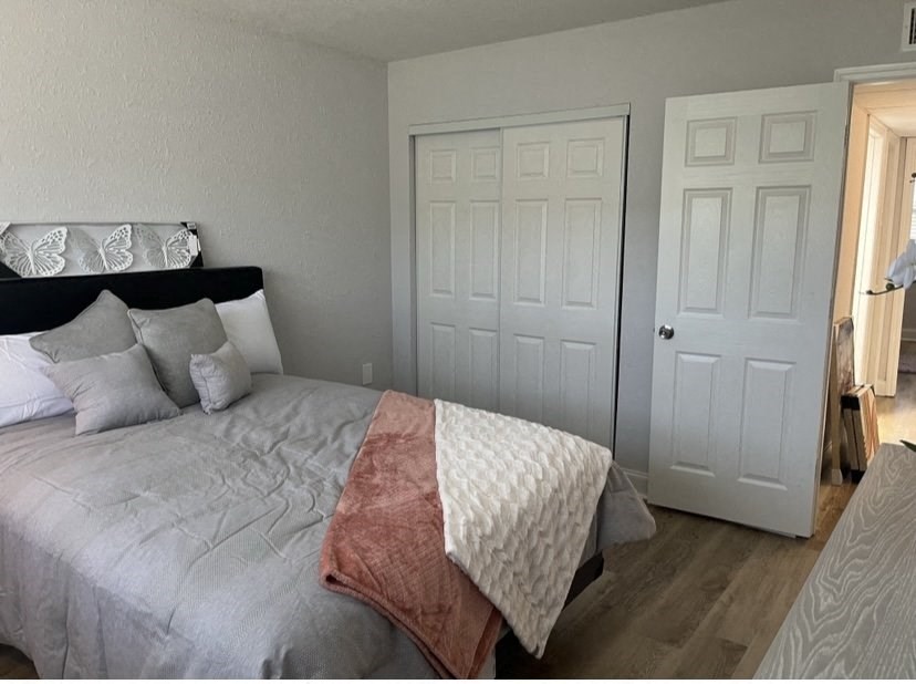 a bedroom with a bed and a door