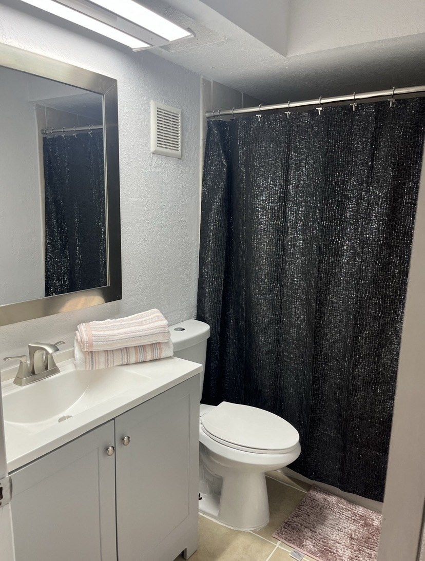 a bathroom with a toilet sink and shower