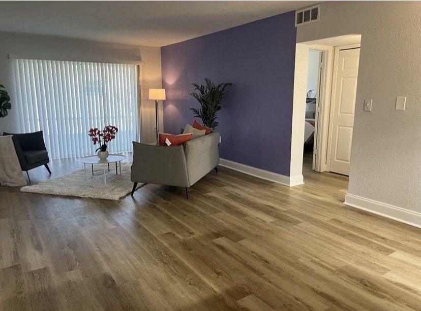 a living room with a purple accent wall