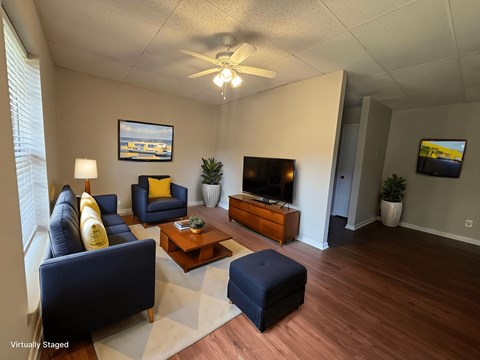 A living room with a blue couch and a television.