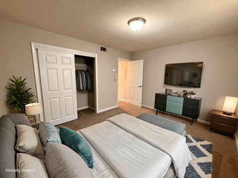 A bedroom with two beds and a dresser with a mirror above it.