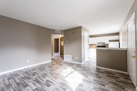 A room with a wooden floor and a white ceiling.