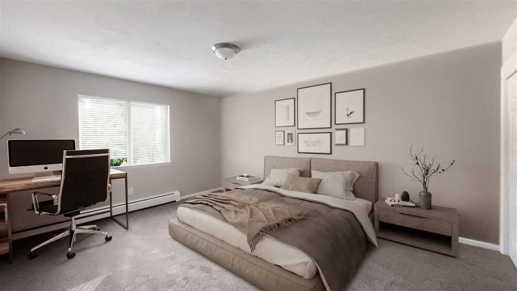 a bedroom with a bed and a desk with a computer