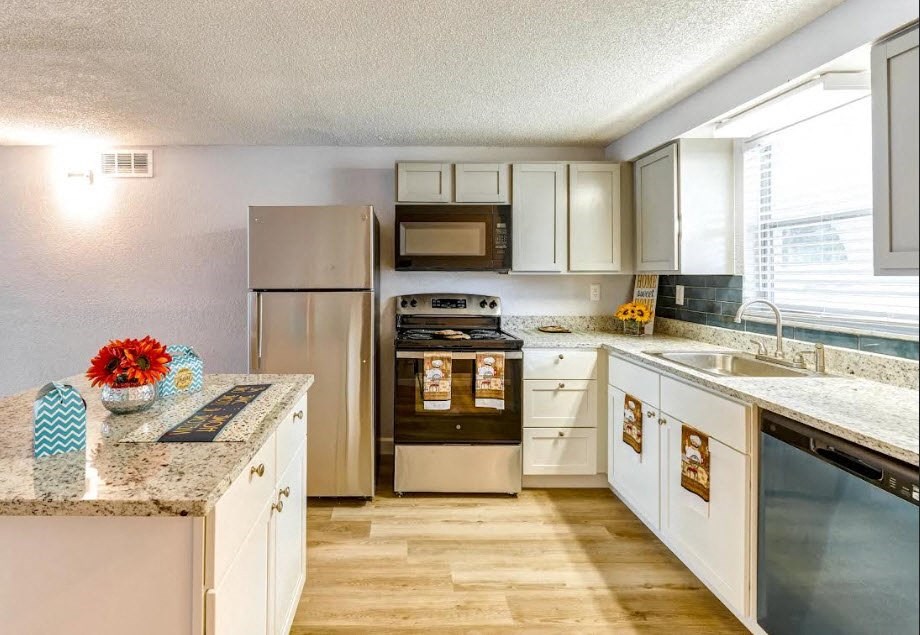 a kitchen with stainless steel appliances and granite counter tops