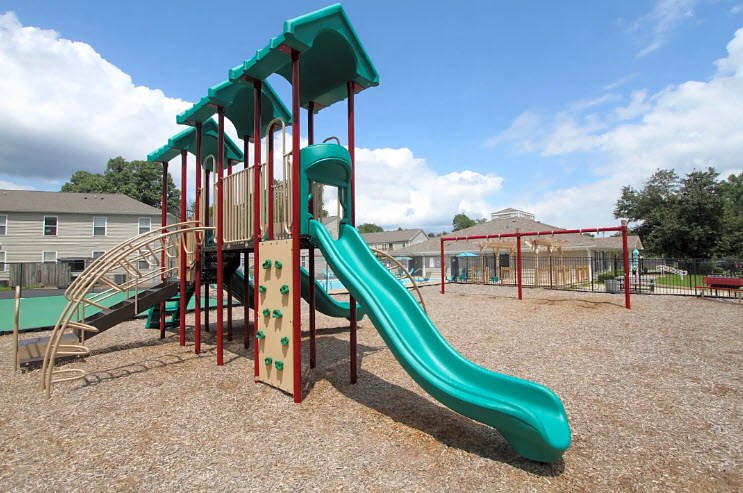 a playground with a slide at a park