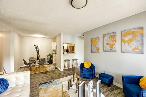 A living room with a white couch and blue chairs.