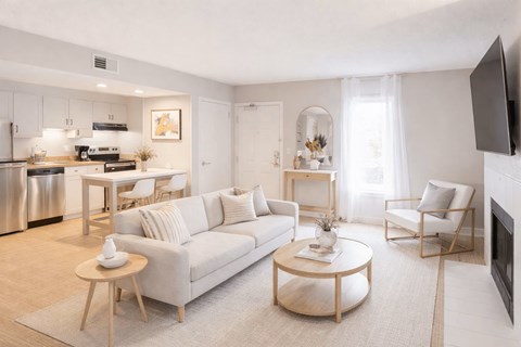 A modern living room with a white sofa and a coffee table.