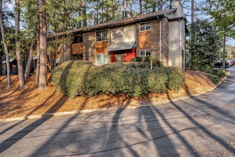 a house with a red door on the side of a street