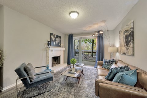 a living room with couches and a glass table