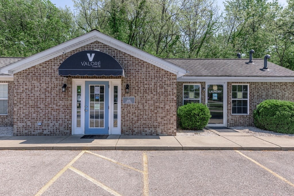 the front of a brick building with a blue sign on it