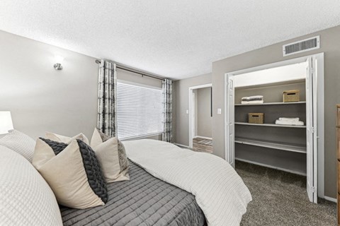 a bedroom with a bed and a closet with shelves