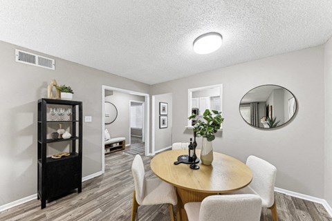a dining room with a table and chairs