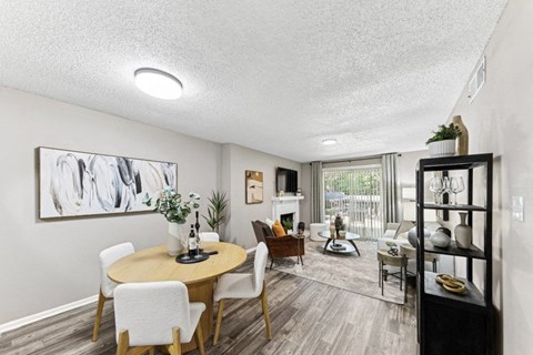 a living room and dining room with a table and chairs