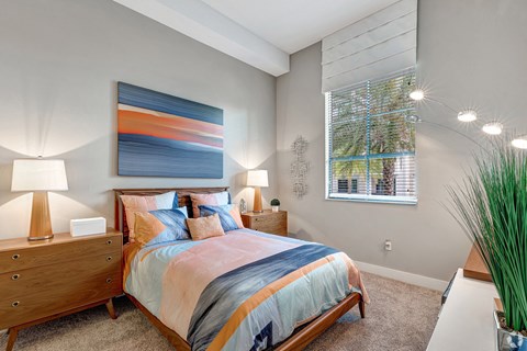 a bedroom with a large bed and a window