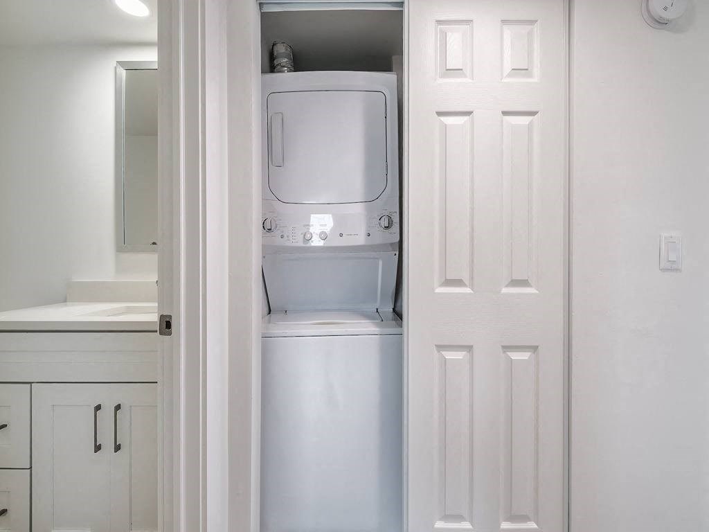 a white washer and dryer in a white closet