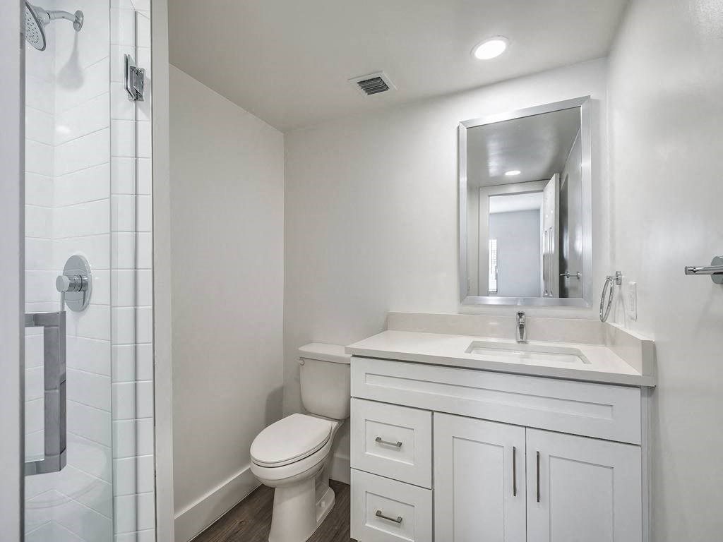 a white bathroom with a toilet and a sink