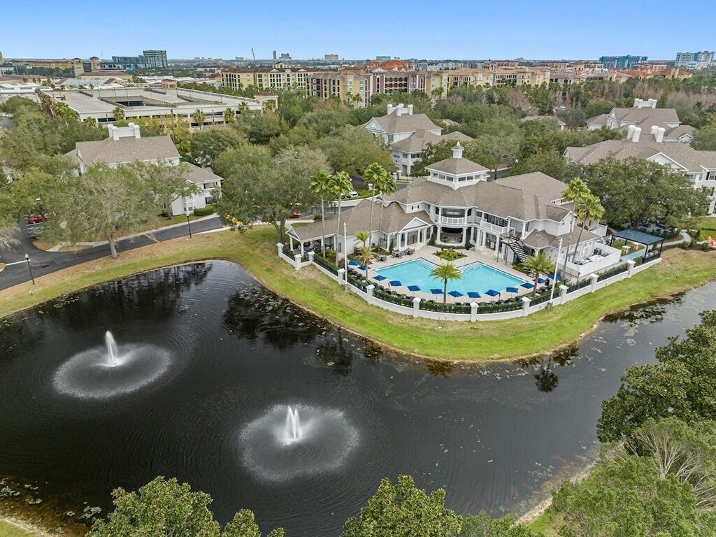 an aerial view of the clubhouse with a pool and water fountain