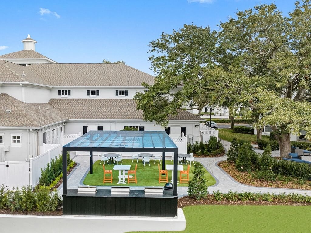 an aerial view of the backyard of a mansion with a garden and a greenhouse