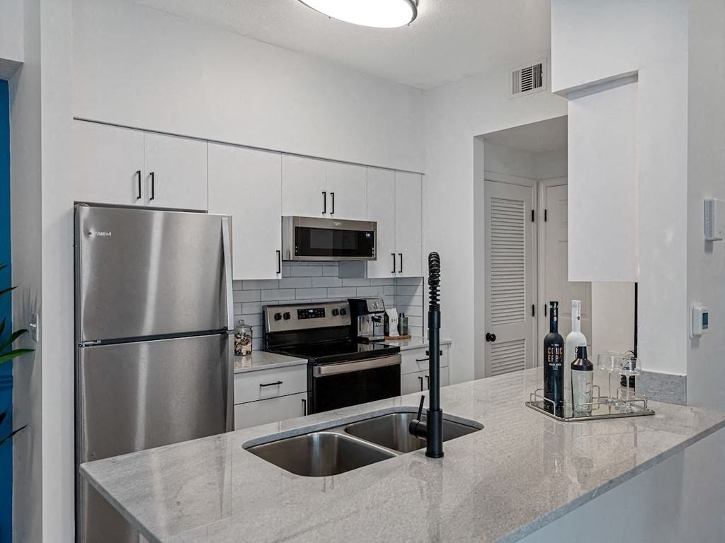 a kitchen with stainless steel appliances and a counter top