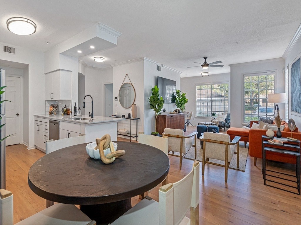 a living room with a dining room table and a kitchen