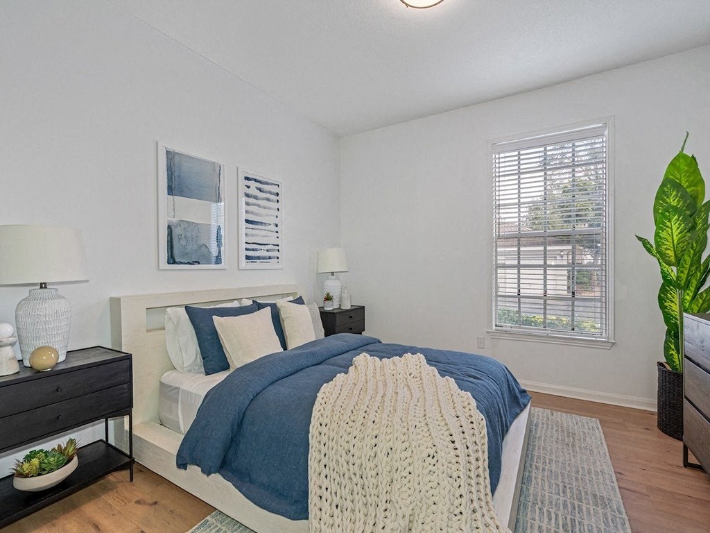 a bedroom with a bed and a window