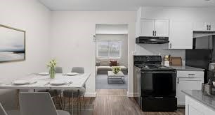 A modern kitchen with a dining table set for four.