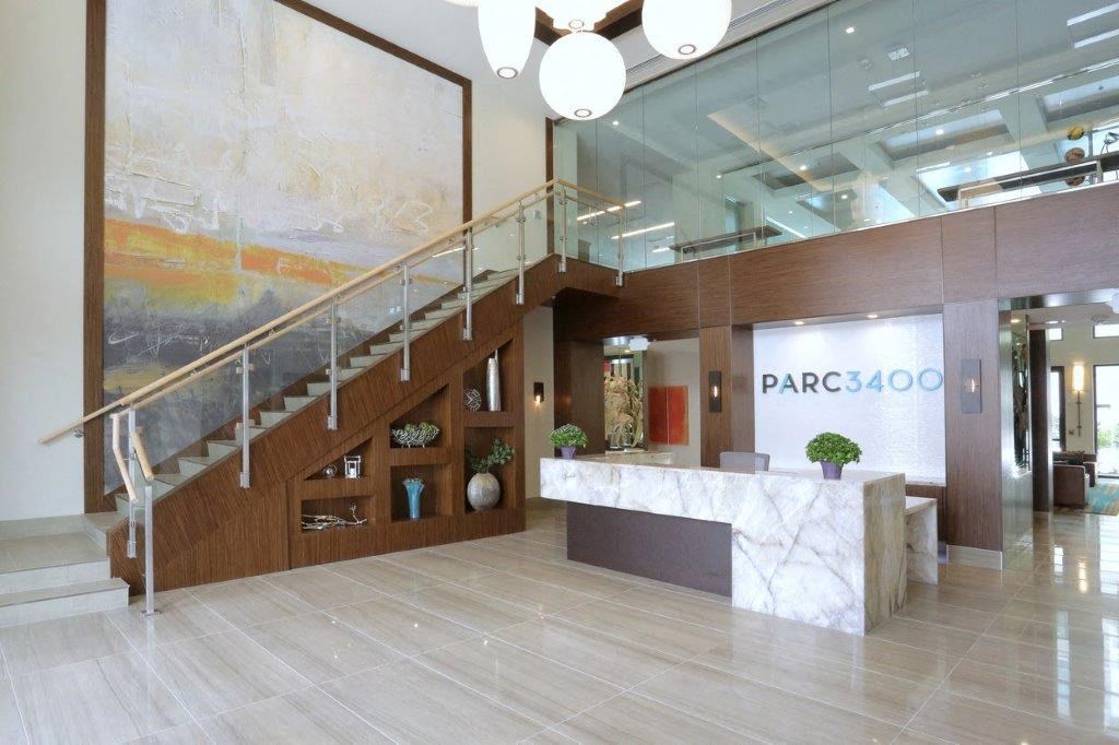 a large lobby with a staircase and a reception desk