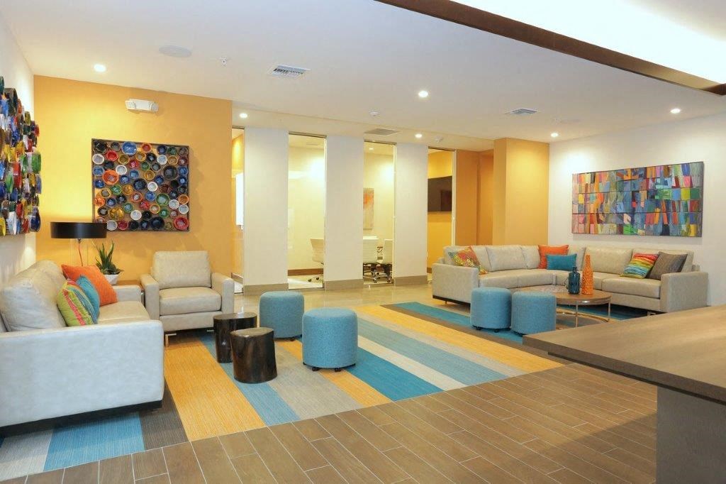 a lobby of a hotel with couches and chairs