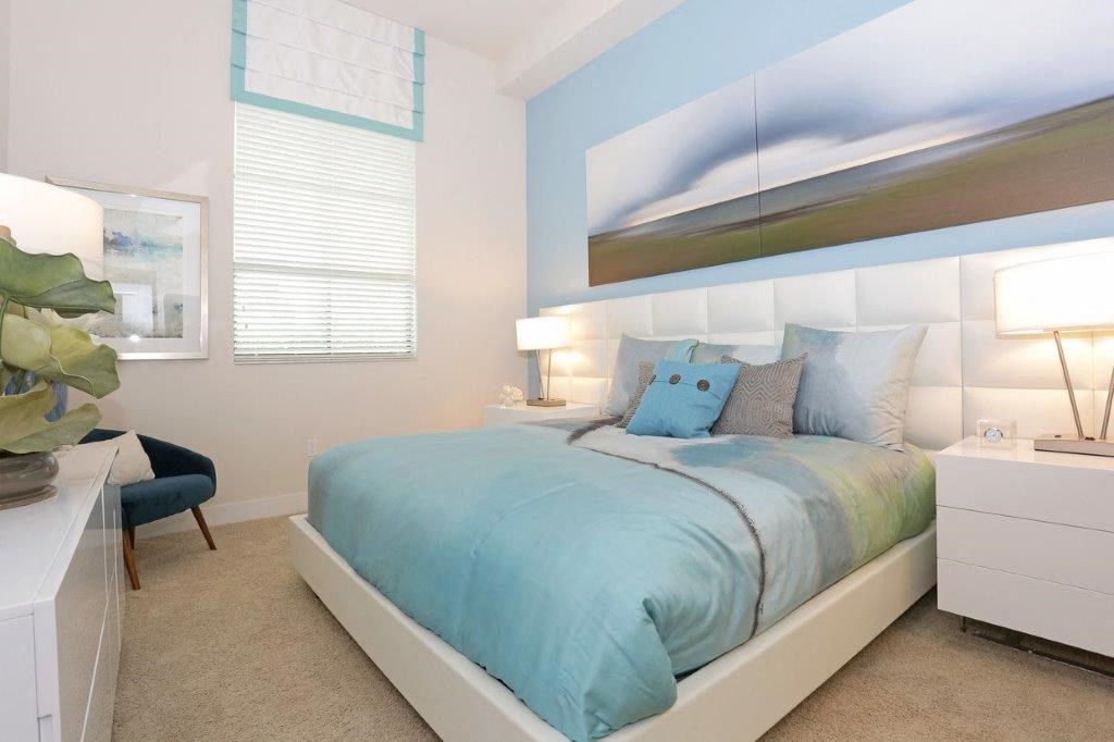 a blue and white bedroom with a bed