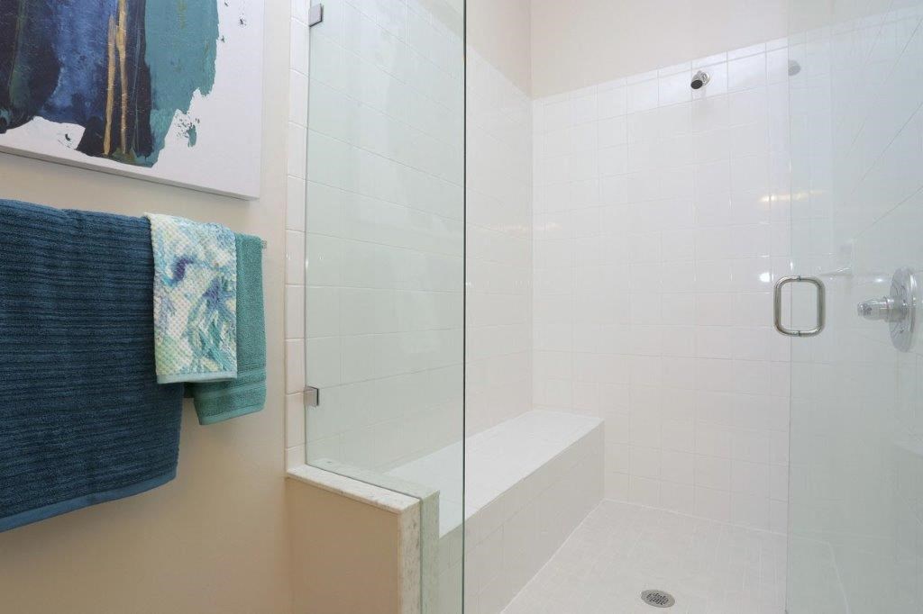 a bathroom with a shower and towels on a towel rack