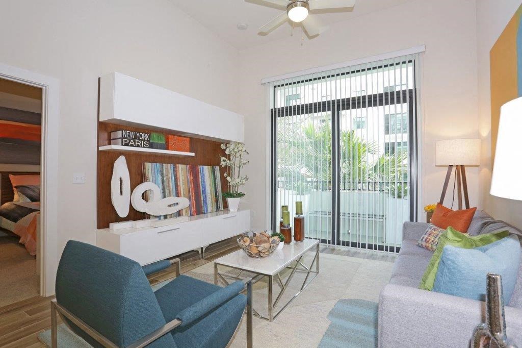 a living room with furniture and a sliding glass door
